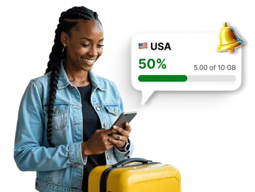 Traveler checking mobile data usage for the USA in an app, with a notification showing 50% of the 10 GB data package used.